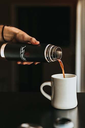 coffee cup person holding thermal carafe coffee
